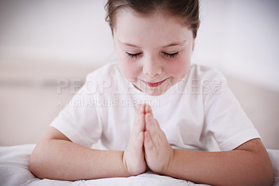 Buy stock photo A young girl saying her prayers before bedtime