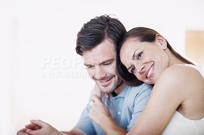 Buy stock photo An affectionate young couple spending time together indoors