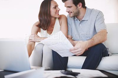 Buy stock photo A married couple being affectionate while they discuss their home finances