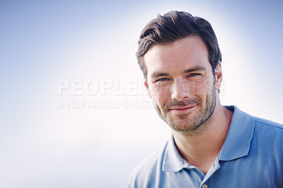 Buy stock photo Head and shoulders shot of a handsome young man standing outside