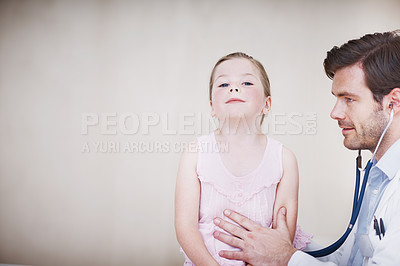 Buy stock photo A young male doctor performing a medical examination on a little girl