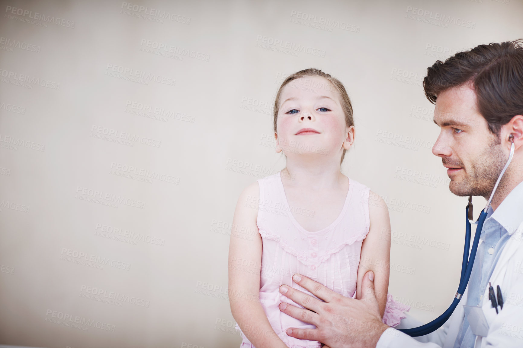 Buy stock photo A young male doctor performing a medical examination on a little girl
