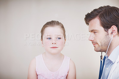 Buy stock photo Shot of a little girl having her annual medical checkup done by a doctor