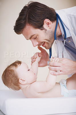 Buy stock photo A male doctor examining an infant girl