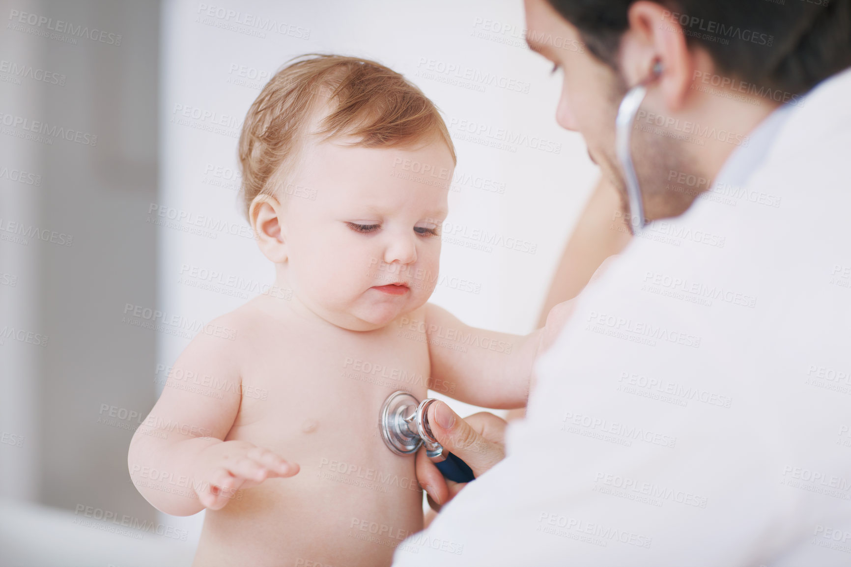Buy stock photo A male doctor examining an infant girl with a stethoscope