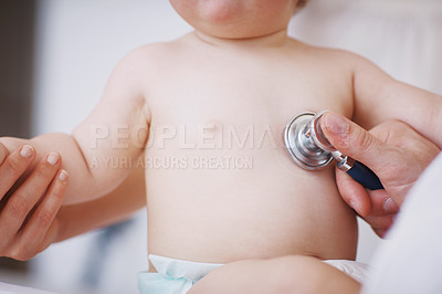 Buy stock photo Cropped shot of a doctor examining an infant girl with a stethoscope