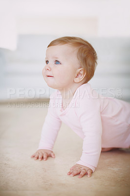 Buy stock photo A little baby girl crawling on the floor indoors
