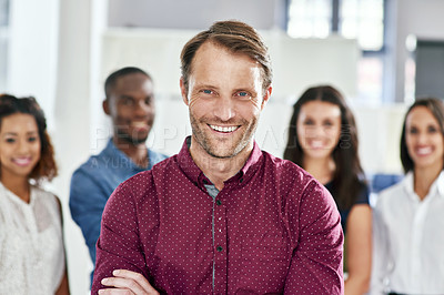 Buy stock photo Portrait of a businessman with his coworkers standing behind him