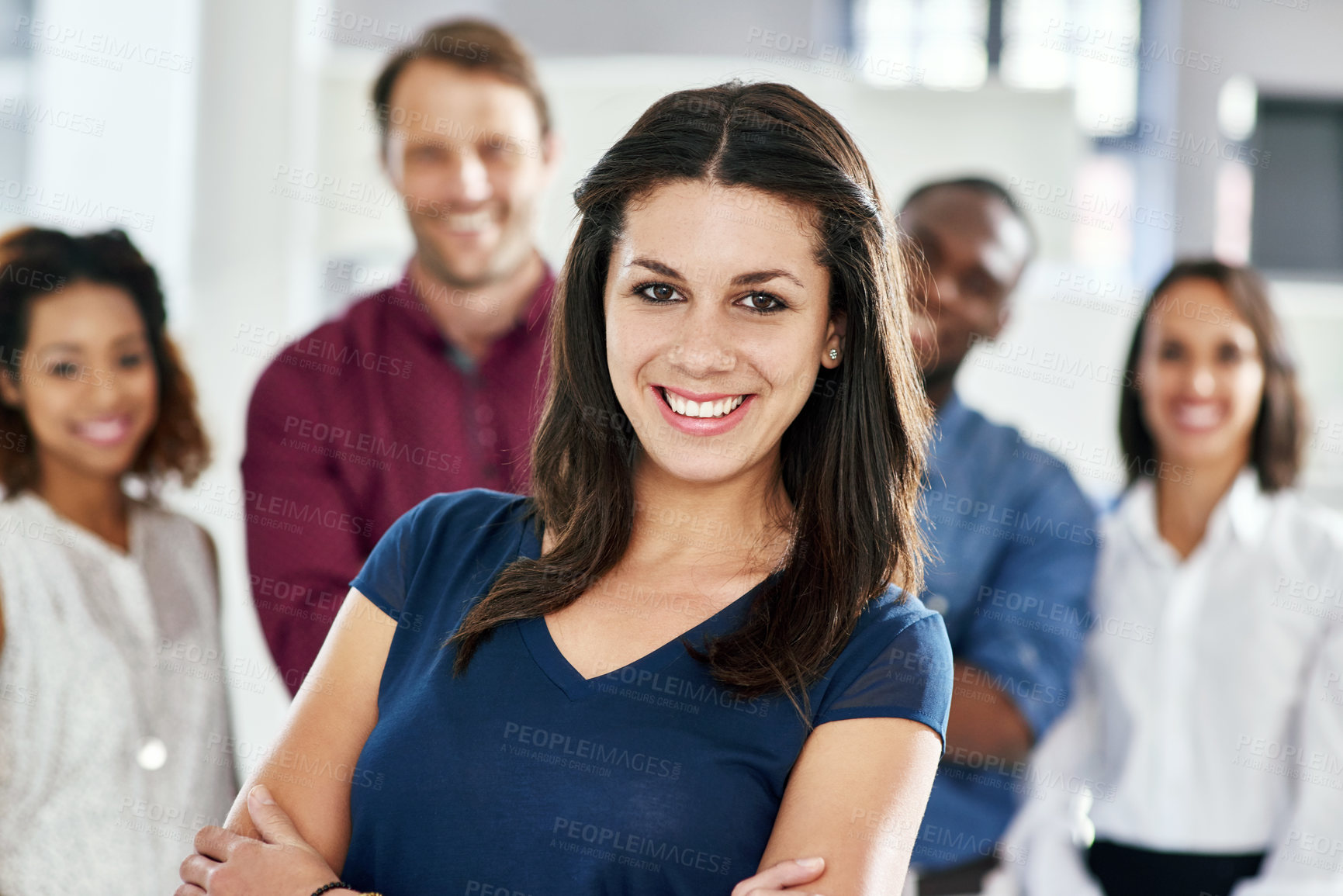 Buy stock photo Portrait of a businesswoman with her coworkers standing behind her