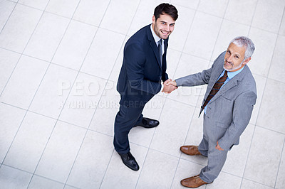 Buy stock photo Portrait, handshake and smile of business people with CEO for deal, collaboration or b2b partnership agreement for consultant. Top view, shaking hands or men in office for acquisition on mockup space