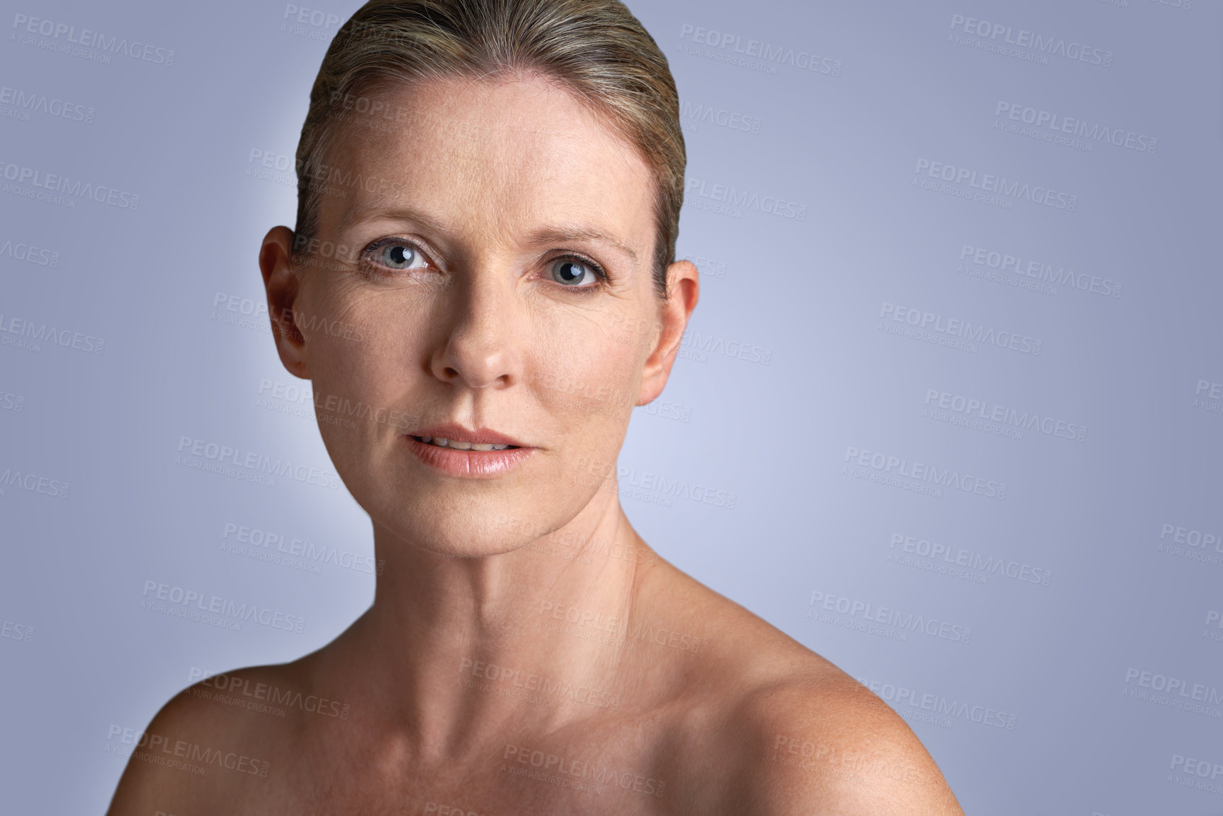 Buy stock photo Face, beauty and portrait of mature woman doing cosmetic skincare facial isolated in a blue studio background. Cosmetics, care and old female model calm with natural skin  due to anti aging 