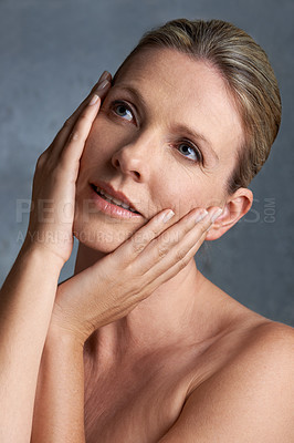 Buy stock photo Face, skincare and thinking with mature woman in studio on gray background for aesthetic wellness. Beauty, relax and hygiene with natural skin person at spa for antiaging cosmetics or treatment
