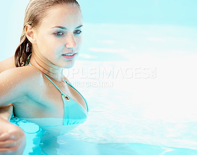 Buy stock photo Woman, swimming pool and relax in bikini, summer and sunshine for health, wellness or mockup space on holiday. Girl, person and outdoor with swimwear in water for vacation, freedom or peace in Spain