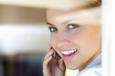 Buy stock photo Closeup of a cute young woman speaking over the cellphone