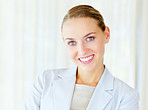 Cute business woman smiling against bright background
