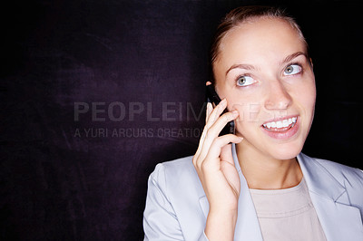 Buy stock photo Happy young business woman speaking over cellphone against black
