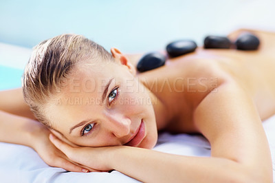Buy stock photo Spa, portrait and woman with hot stone massage, relief or stress relief body treatment at a wellness resort. Luxury, zen and face of female person at a salon for healing, therapy or pamper vacation