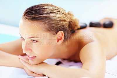 Buy stock photo Hot stone, back massage and relax woman at a spa for wellness treatment and detox. Calm, muscle healing recovery and a female person with sleep at resort or hotel with beauty therapist with skincare