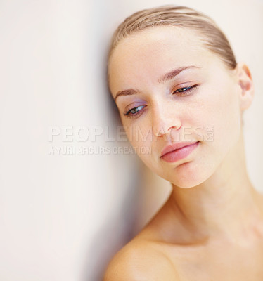 Buy stock photo Thinking, beauty and space with a young woman on a wall background for wellness or natural treatment. Relax, skincare and idea with a person at the spa or salon for dermatology or self care on mockup