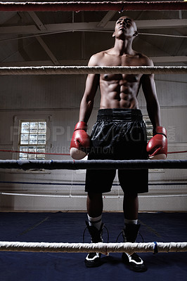 Buy stock photo Full length of muscular African American male boxer standing in ring looking away