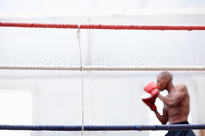 Buy stock photo Portrait of African American athletic man practicing with boxing gloves in ring
