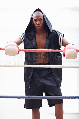 Buy stock photo Portrait of African American athletic man in black hooded robe wearing boxing gloves