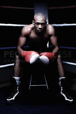 Buy stock photo Confident African American male athletic sitting in ring wearing gloves