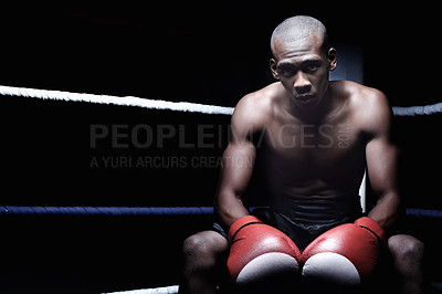 Buy stock photo Portrait of smart African American male athletic sitting in ring wearing gloves