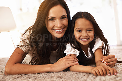 Buy stock photo Happy mother, portrait and child hug in relax on floor for bonding, love or care together at home. Face of mom, parent and little girl, daughter or kid with smile in living room for family time