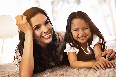 Buy stock photo Happy mom, portrait and hug with child in relax on floor for bonding, love or care together at home. Face of mother, parent and little girl, daughter or young kid with smile for family in living room