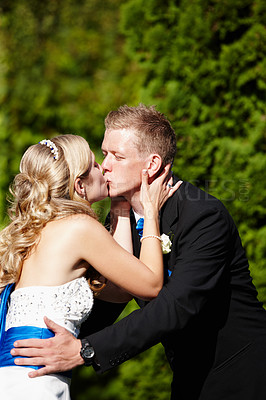 Buy stock photo Shot of a bride and groom kissing on their wedding day