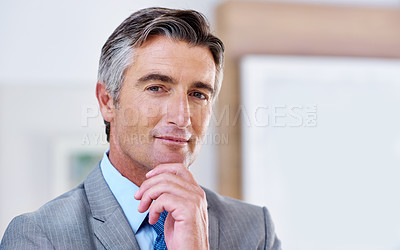 Buy stock photo Portrait of a confident-looking mature businessman with his hand on his chin
