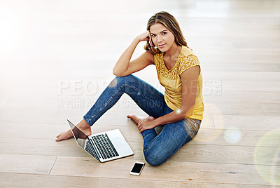 Buy stock photo Portrait of a young woman sitting on the floor with her cellphone and laptop