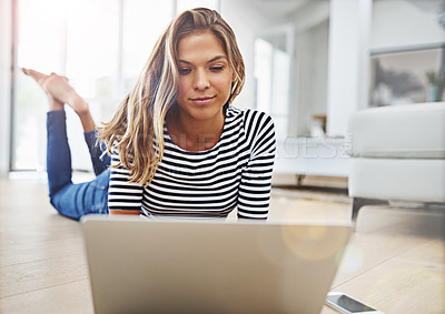 Buy stock photo Woman, relax and lying with laptop on floor in living room with streaming, video and subscription in home. Person, computer and happy with search, smartphone and check notification on social media