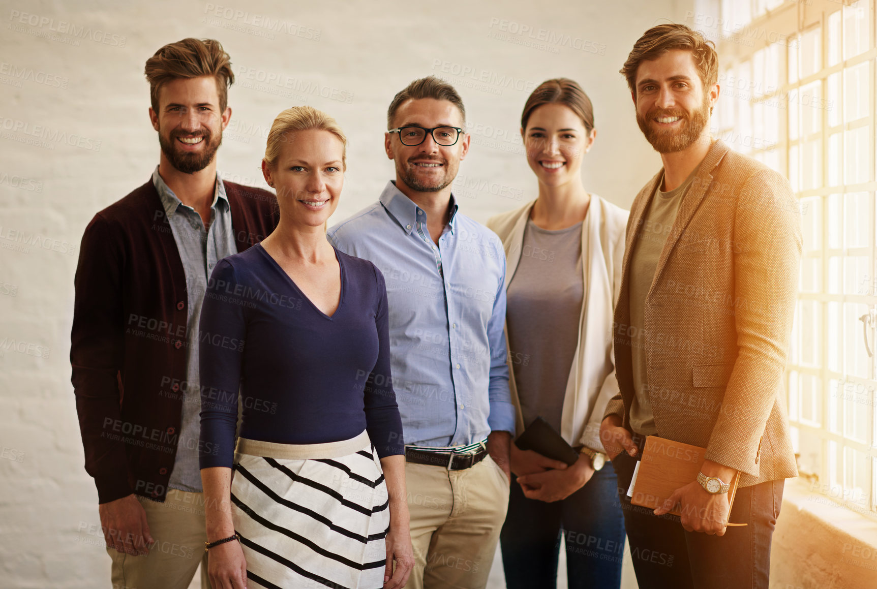 Buy stock photo Cropped portrait of a business team standing in their office