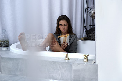 Buy stock photo Woman, bathtub and reading book in home, hobby and novel for selfcare growth or inspiration. Female person, comfort literature and fiction fantasy for peace, info and romance story for entertainment