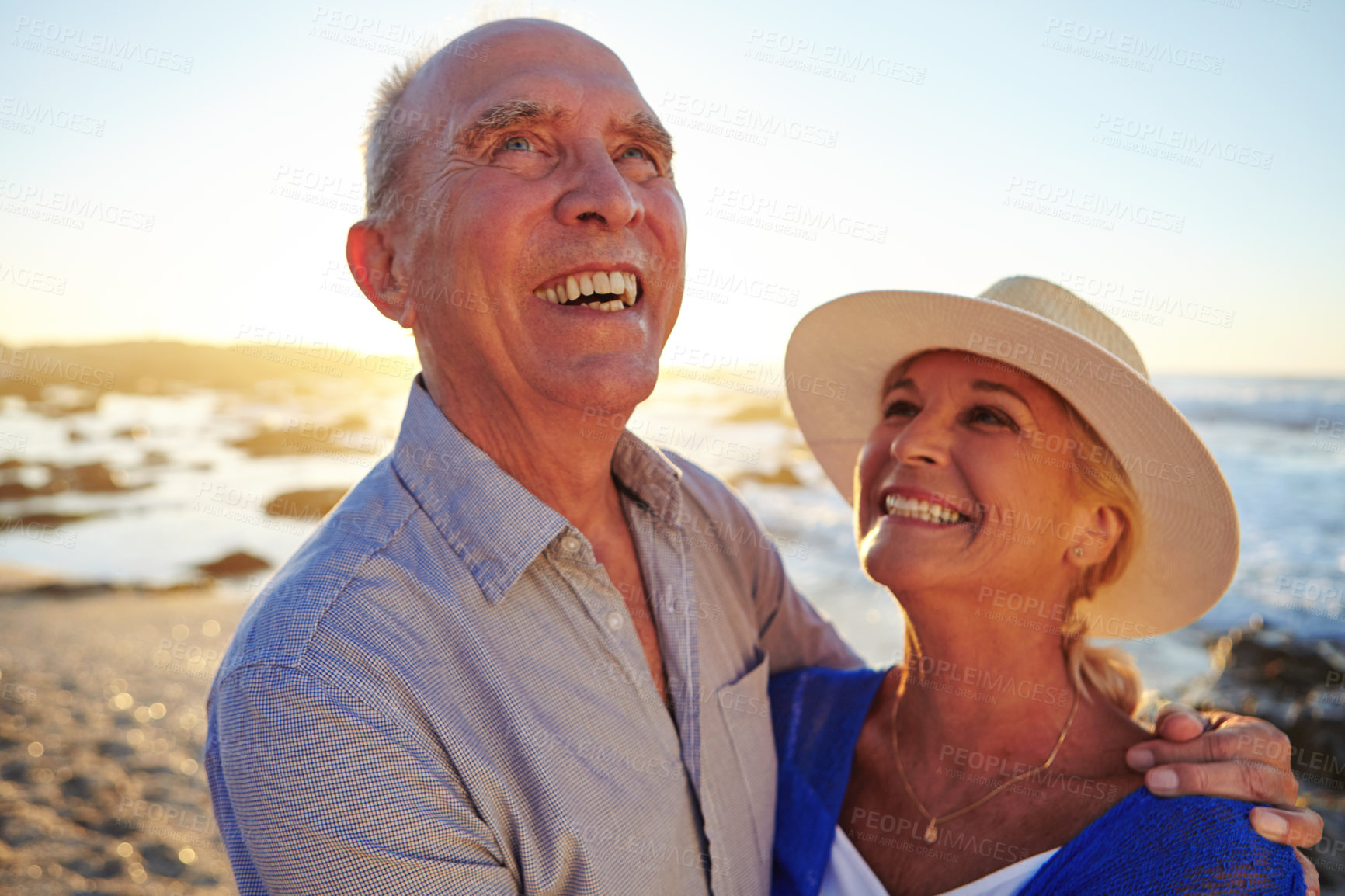 Buy stock photo Shot of an affectionate senior couple walking on the beach