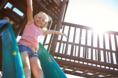 Buy stock photo Shot of a little girl playing on a jungle gym