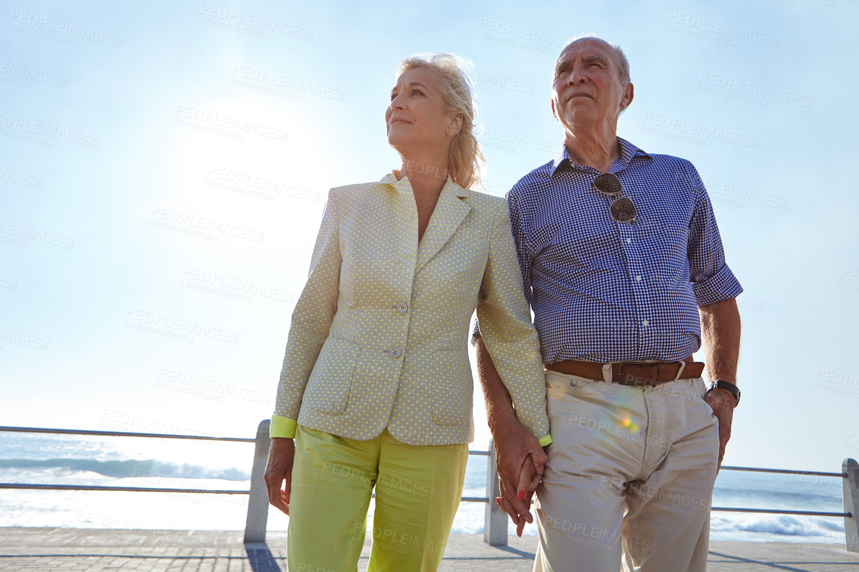 Buy stock photo Shot of a senior couple taking a walk by the ocean