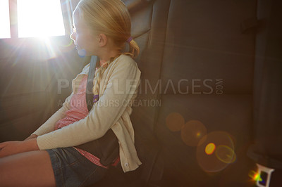 Buy stock photo Shot of a little girl traveling in a car