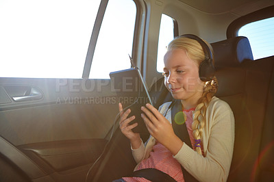 Buy stock photo Shot of a little girl traveling in a car