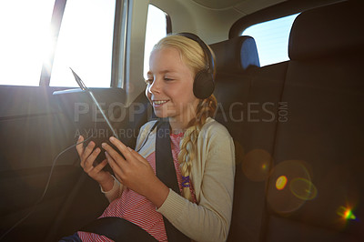 Buy stock photo Shot of a little girl traveling in a car