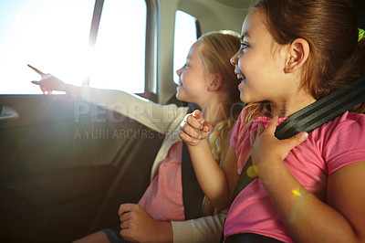 Buy stock photo Shot of a two little girls traveling in a car