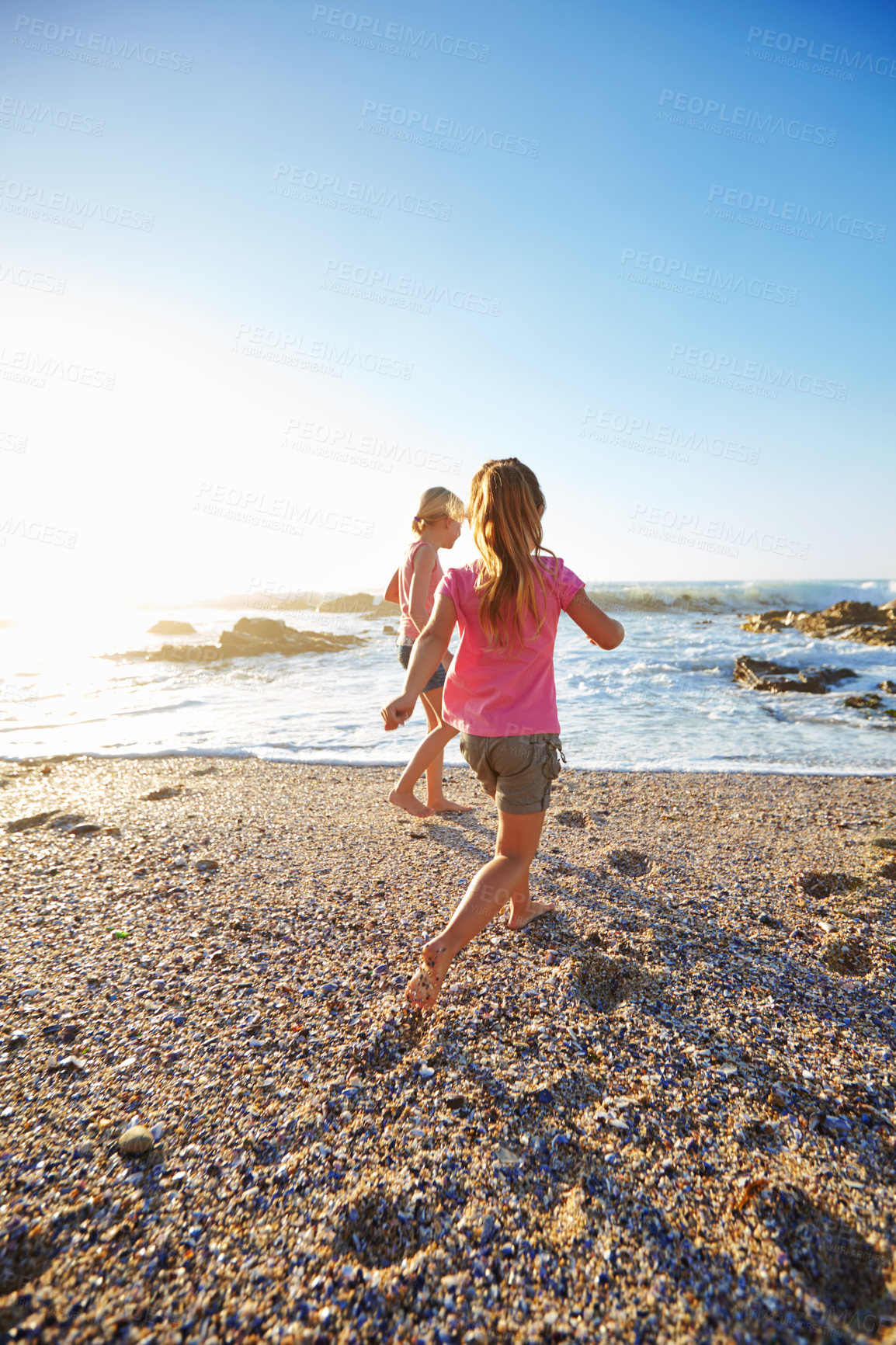 Buy stock photo Shot of two little girls having fun on the beach