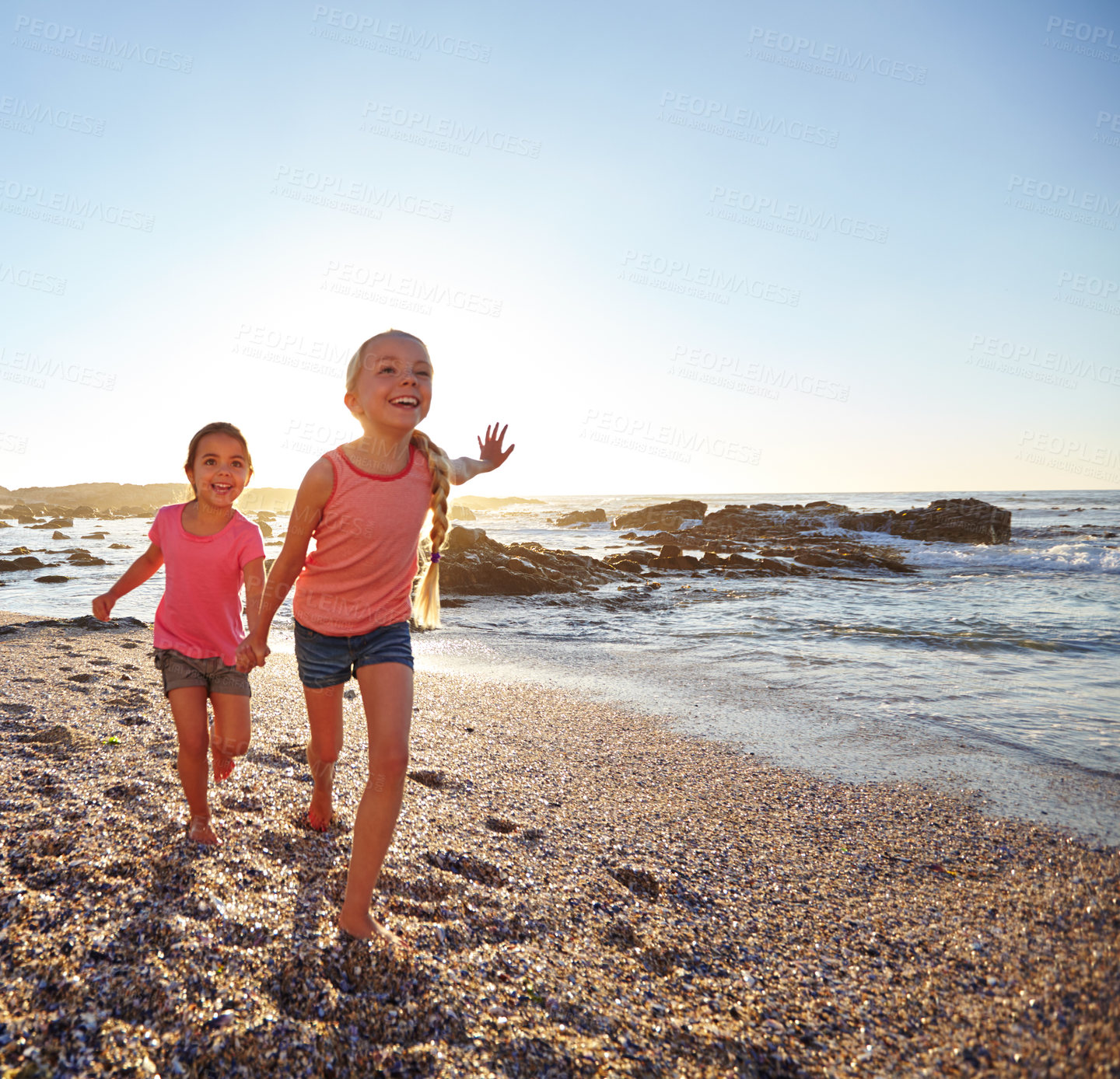 Buy stock photo Shot of two little girls having fun on the beach