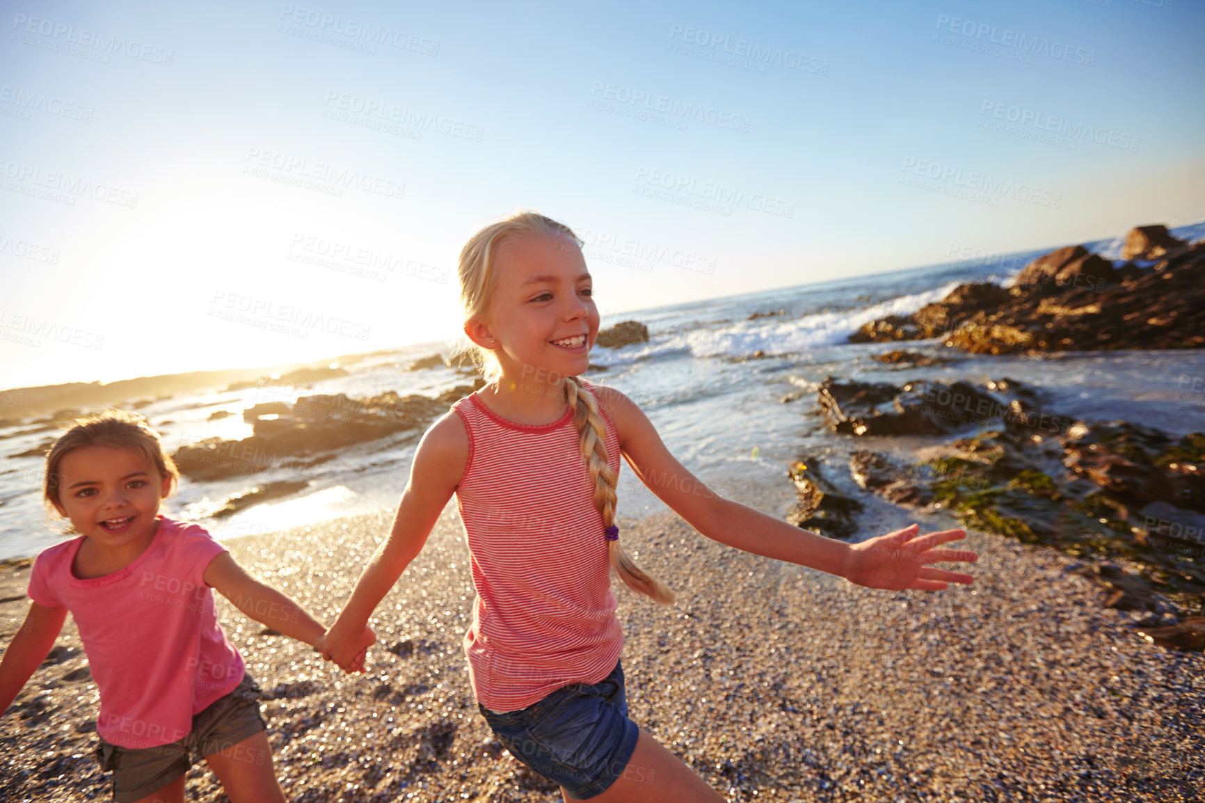 Buy stock photo Shot of two little girls having fun on the beach