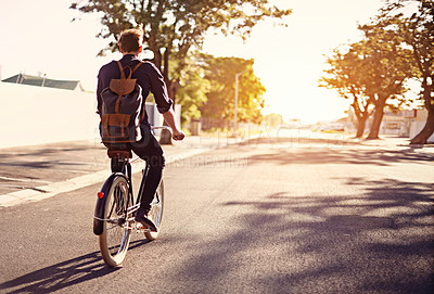 Buy stock photo Bicycle, transport and back of man in road with lens flare for exercise, commute and cycling in morning. Travel, city and male cyclist on bike for eco friendly traveling, carbon footprint and journey