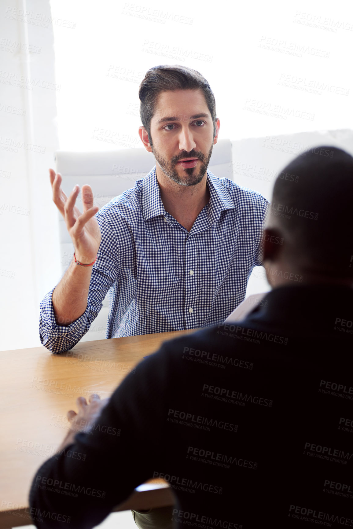 Buy stock photo Shot of a businessman interviewing a job applicant in an office