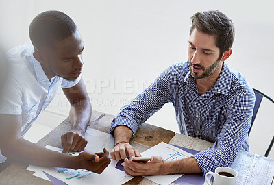 Buy stock photo Shot of two businessmen having a meeting in an office