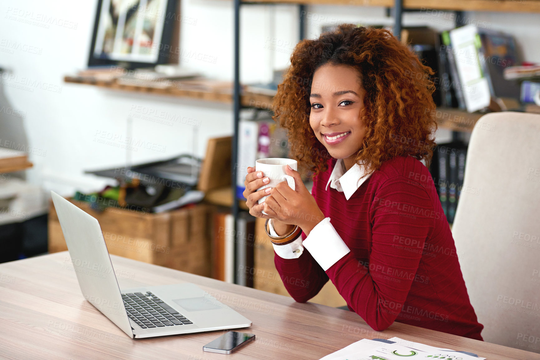 Buy stock photo Shot of a young woman working on a laptop in an office